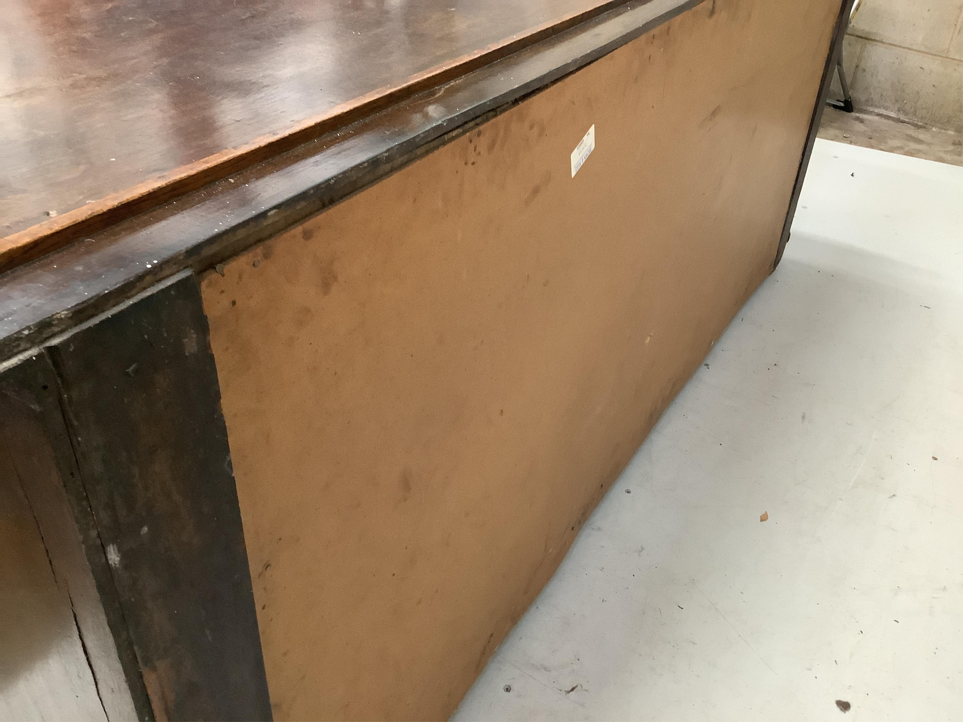 A mid 18th century oak low dresser, fitted seven small drawers, flanked by fielded panelled cupboards, width 192cm, depth 48cm, height 81cm. Condition - fair